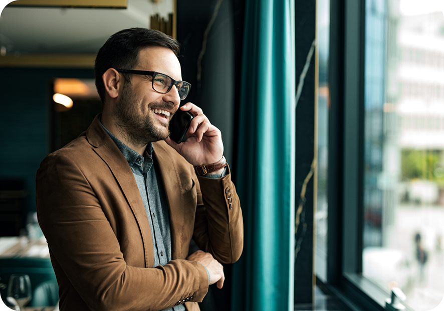 Man with glasses talking on phone