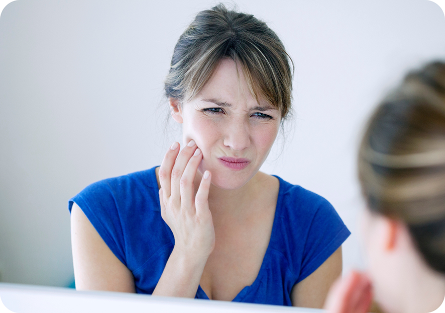 Woman in blue shirt with tooth pain