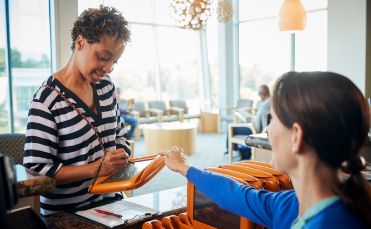Female patient taking tablet from team member