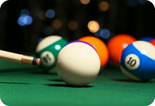 About to hit cue ball on billiards table