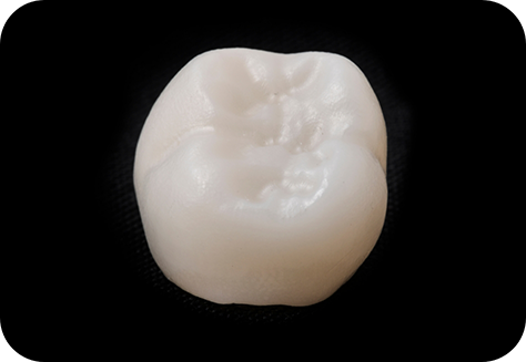 Close up of dental crown on black background