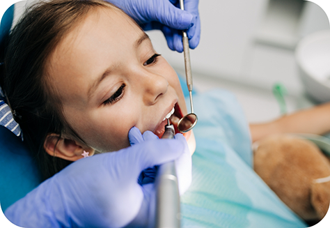Young female patient having teeth examined