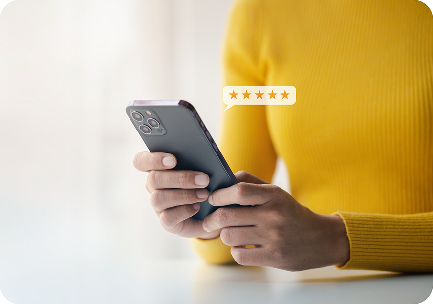 Person in yellow shirt leaving review on phone