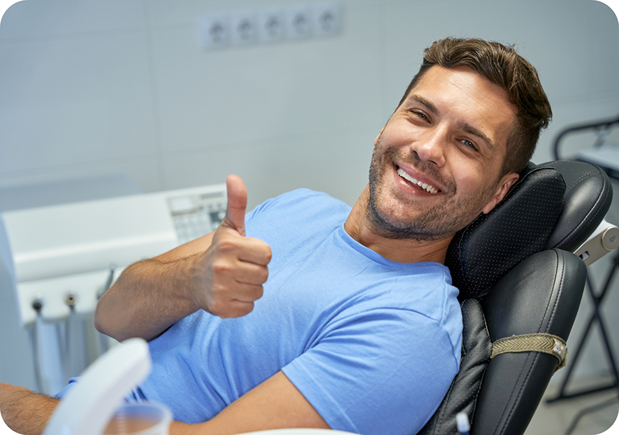 Man in blue shirt smiling and giving thumbs up