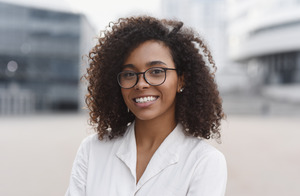 Smiling woman with glasses and white shirt